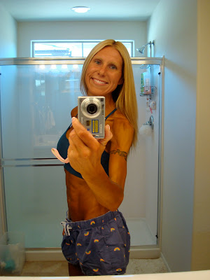 Woman showing off spray tan in mirror