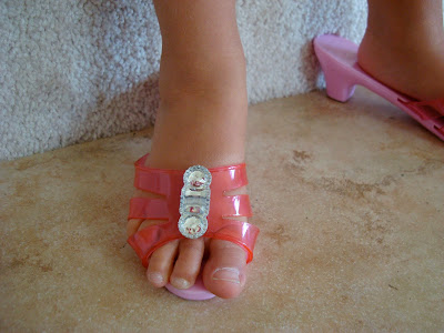 Young girl wearing small heel pink sandals
