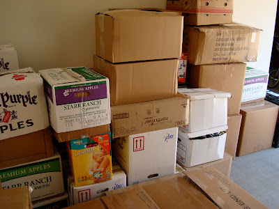 Stacked moving boxes against wall