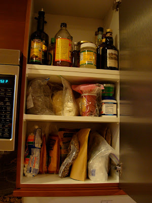 Unpacking with cabinet full of food items