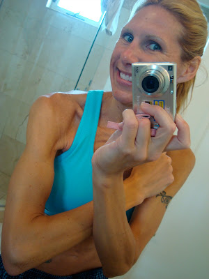 Woman flexing arms in mirror