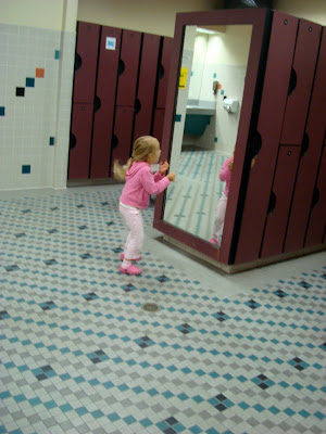 Young girl dancing in front of mirror