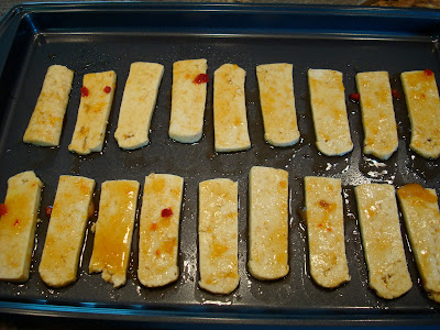 Mango Ginger Maple Tofu spread out in even rows on baking sheet