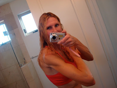 Woman flexing in front of mirror