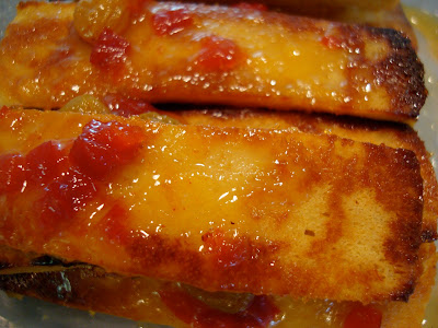 Close up of sliced and stacked Mango Ginger Maple Tofu in container
