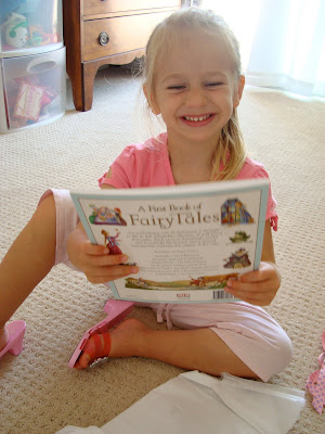 Young girl holding book and smiling