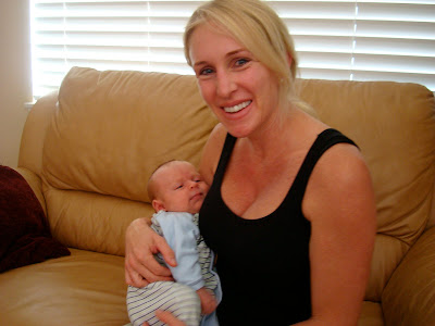 Woman sitting on couch holding baby