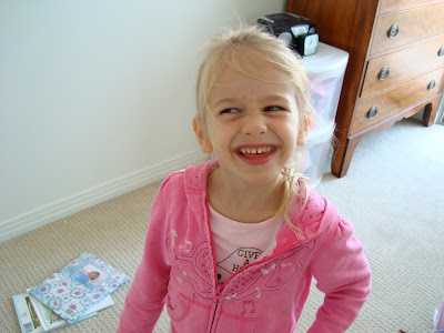 Little girl smiling in bedroom