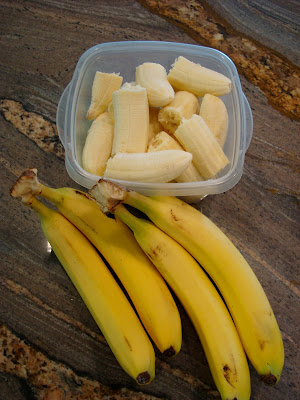 Bunches of bananas and sliced bananas in clear container - 69