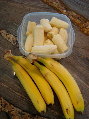 Bunches of bananas and sliced bananas in clear container