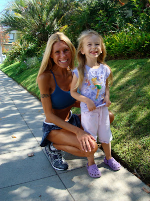 Smiling young girl with woman behind her also smiling