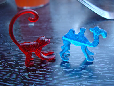 Red plastic monkey and blue plastic camel