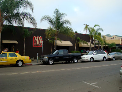 Restaurant with cars parked on street with palm trees - 3