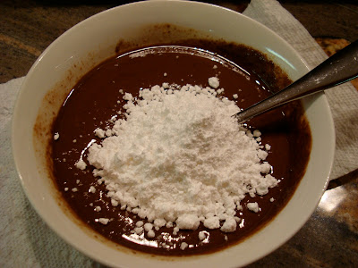 Powdered sugar added to frosting mixture