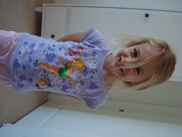 Young girl with hands behind back smiling - 26