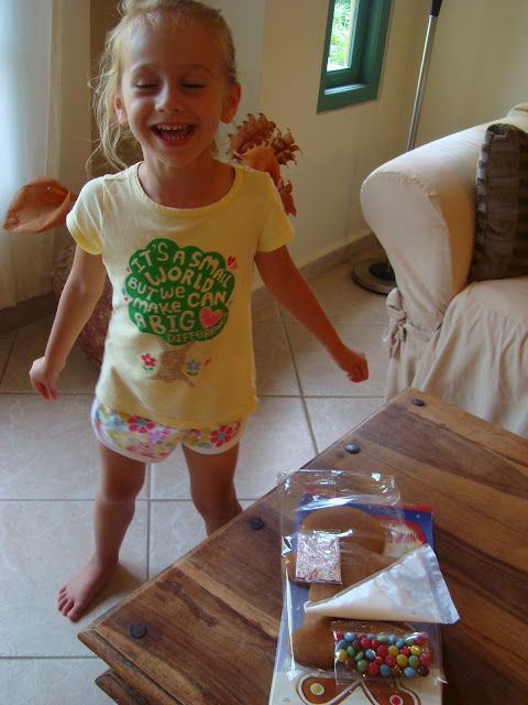 Girl dancing by table with Gingerbread Man Kit