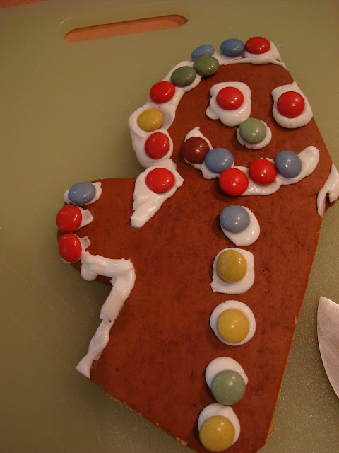 Close up of cut up gingerbread man on cutting board