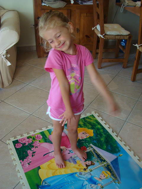 Young girl standing on princess mat