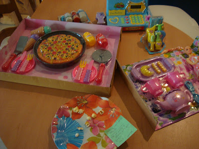 Multiple open children's christmas presents on table - 7