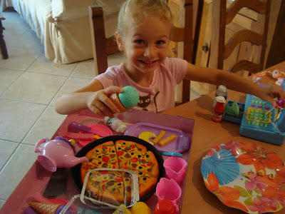 Young girl playing with open christmas presents
