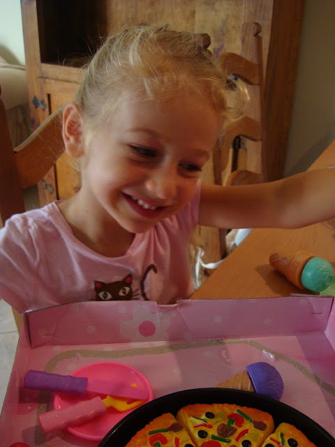 Young girl smiling while playing with gift