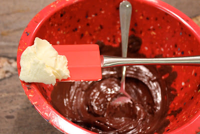 Butter being added to melted chocolate