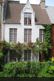 Canalside house with roses around the windows