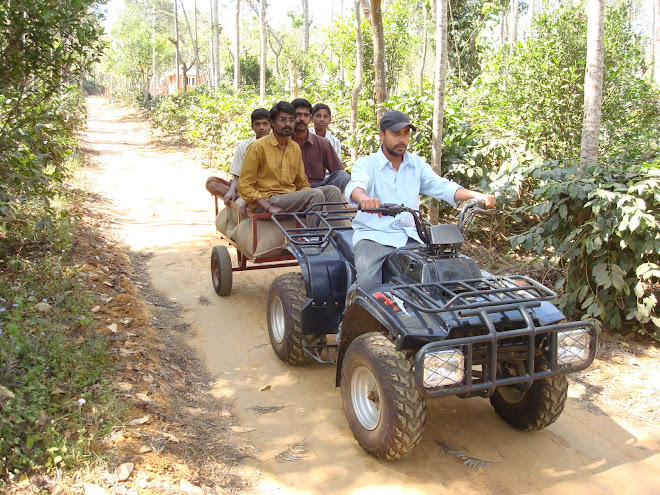 INDIAN FARMER USING ATV IN HIS COFFEE PLANTATION