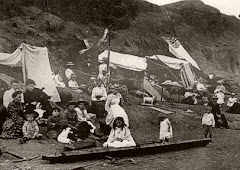 Dug-outs in the debris heaps, showing the daily activities of civilians during the quieter moments.