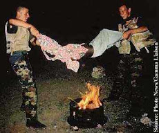 What they call U.N. Peacekeepers hold a Young Somali boy above an open flame in 1993.