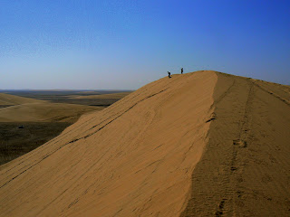 Running down a sand dune in the Qatar desert