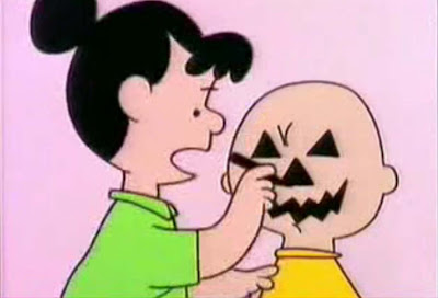 Violet uses Charlie Brown's head as a model for a jack o' lantern