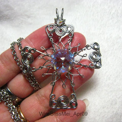 Holding the Wire wrapped Montrance with crystal focal