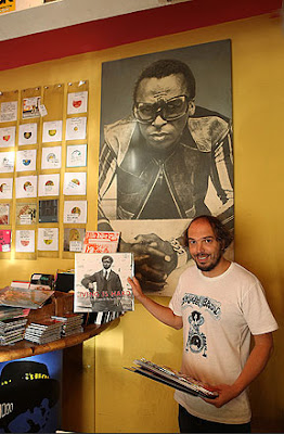 Sales clerk Mathieu Jurgawczynski at Honest Jon's Records on London's Portobello Road. The shop specializes in world music albums, such as this copy of 