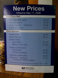 new prices of postage stamps on a sign at a post office