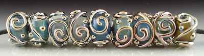 Triton encased beads with Triton scrolls