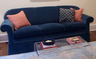 turquoise and orange accent pillows on sofa
