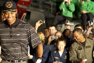 Crewmembers photograph professional golfer Tiger Woods as he walks through the hanger bay of the nuclear powered aircraft carrier USS George Washington (CVN 73). U.S. Navy photo by Photographer's Mate 1st Class Brien Aho. (RELEASED)