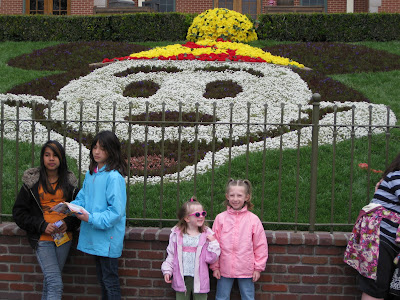 Mandi and Kimmie in front of the Mickey flowers