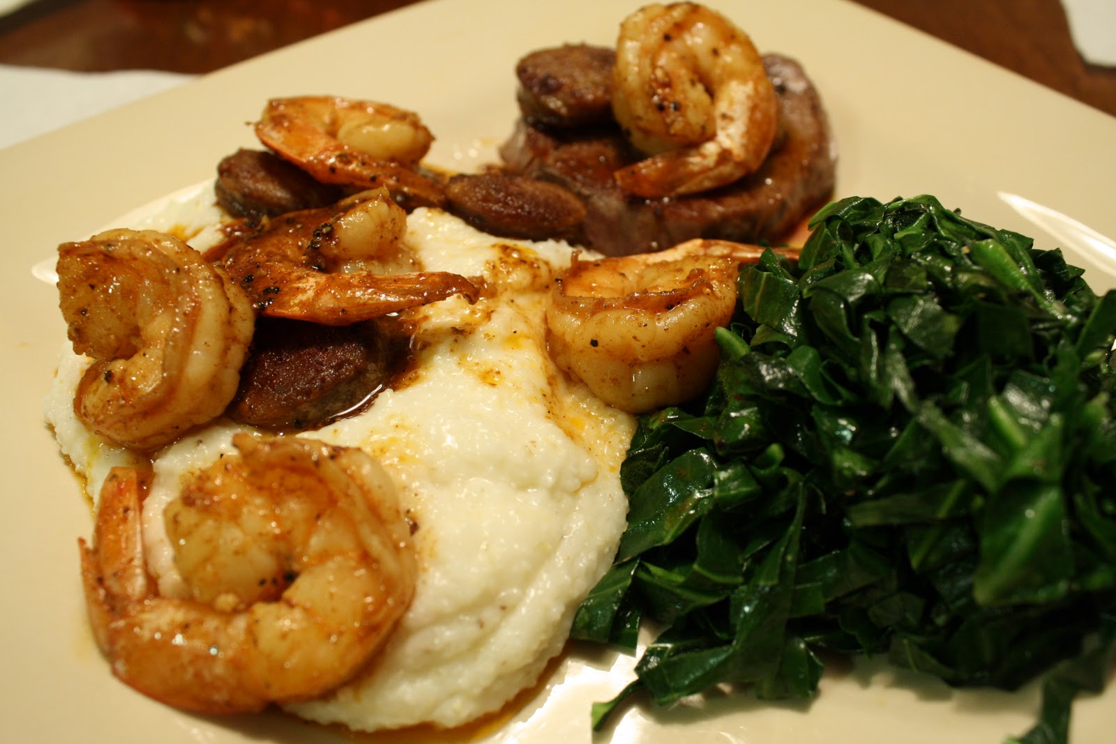 Living on Pure Land New Orleansstyle shrimp and sausage over steaks with cheesy grits and
