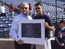 Astronaut Shane Kimbrough presents a picture of Atlanta taken from space to Braves General Manager Frank Wren