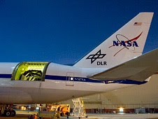 The SOFIA airborne observatory's 2.5-meter infrared telescope peers out from the SOFIA 747SP's rear fuselage during nighttime line operations testing