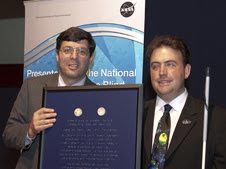 NASA Associate Administrator Chris Scolese, left, presented Mark Riccobono, executive director of the Jernigan Institute of the National Federation of the Blind a Braille-inscribed award with two Louis Braille Bicentennial Silver Dollars flown on Atlantis' STS-125 mission