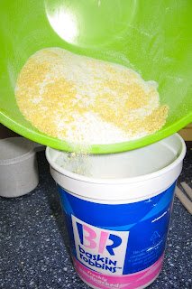 putting laundry detergent into recycled container