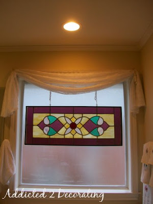Master bathroom before redesign--large window above tub needed a more appropriate window treatment