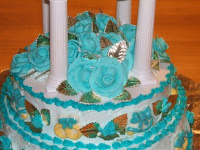 50th anniversary cake with teal blue roses and gold leaf