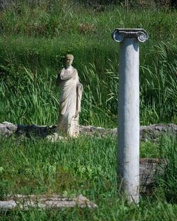 grass in greece with statue framgents