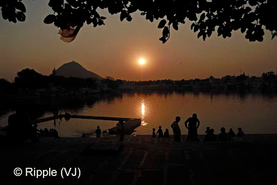 Posted by Ripple (VJ) :  Pushkar Camel Fair 2008 : Sunset View from Jaipur-Ghat @ Pushkar: The small and beautiful town of Pushkar is set in a valley just about 14 km off Ajmer in the north Indian state of Rajasthan. Surrounded by hills on three sides and sand dunes on the other, Pushkar forms a fascinating location and a befitting backdrop for the annual religious and cattle fair which is globally famous and attracts thousands of visitors from all parts of the world.