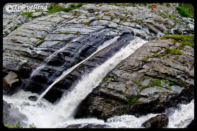 Waterfalls on the way to Mani Mahesh Lake : A lonhg trek through Pir Panjal mountain range of Himalyas : PART-2 : posted by VISHAL SHARMA at www.travellingcamera.com : Continuing with PHOTO JOURNEY to Manimahesh, here are are few more photographs of huge waterfalls on the way to Manimahesh lake in Chamba... Have a look and enjoy... Pilgrims having rest near freshening waterfalls...  I guess water of this fall was touching their body at this place... Manimahesh is considered as very important yatra and I know many of neighbors in Ghumarwin who have visited Manimahesh in last few years.. and many of them go there every year or alternate year... These are few waterfalls which could be seen from the trekking paths to Manimahesh... We had brought binoculars and could see lot many waterfalls on very high mountains of Himalayas... and its very difficult for me to describe those... Huge in size and powerful in throw of water...Here is another waterfall.. I guess it was near to Bheem Dwari and we had snacks near this, while climbing up... I don't know how to define these water streams which have multiple falls and some small streams flowing calmly towards the final destination.... but they were more attractive... How a waterfall looks has very big role of the hill from where its originating and overall shape of that hill... Also nicly composed hills give more beautiful view to these falls :-) .. I know description is not what you must be expecting... Black and White photograph of a water stream on the way to Manimahesh Lake.... There are many such streams on the way and sometimes, we needed to cross them... some of us were very excited and elder group was more careful about us :-) 