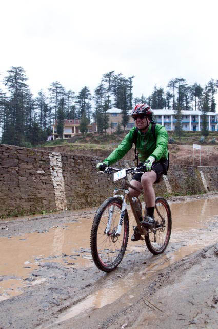 First Day rides during MTB Himachal 2010 - A Road journey in Himalayas : Posted by VJ SHARMA on www.travellingcamera.com : Hope you have already checked flag-off and some glimpses of MTB Himachal 2010... If not, I would recommend you to check out following two links before checking these photographs of very first day...Here are few more photographs of first day of MTB Himachal 2010 - Shimla  Mashobara Shainj (Final Destination for the day)MTB Riders climbing a normal height on good roads on first day...The flagoff from Shimla Ridge was a great improvement over previous year's start from the Peterhoff hotel grounds - more accessible to the general public and the first day's stages were a bit of a warm up... All the riders started from Ridge and moved towards Mashobara.. A few kilometers from Mashobara, first stretch for racing had to start... All set and it started in batches for 8-12 riders...Some of the MTB riders were very fast and they always lead the whole group... A Group from Nepal and another was Indian Army group... They had best cycles as compared to other folks..One of the rider coming towards the bike after taking rest.. It was raining, so some of us stopped riding and rested till it stopped... Notice the road conditions and imagine how they would have been after rains...As far as I remember, there were only two girls who were riding.. One was indian and other was from Nepal... Here is Number 57, Indian Rider who had great sense of humor :-)Another rider of the gang who faced lot of hurdles on the way... But he rode till the end...Every rider had a diary with him/her.. Before starting of any stretch, volunteers used to write down the time in those diaries and duration was calculated on ending of each stretch... Riders used to move in various groups and final timing had to be calculated on last day...Can you guess who are these?Here comes Mr.Rocky with his racing car... For now I am not explaining anything about it because I will have a separate post on this vehicle :-)It had been raining the day before and was still overcast ... After covering few kilometers, it started raining and since we were in Forests of Deodars, there was no place to hide from rains....Here comes Mr Suban Walia, who joined the gang mid-way... I think, he had just parked his Swift to take some photographs of riders on the way.... A true fan of NIKON We met many friends during this event and one of the Photographer called all the dogs with same name 